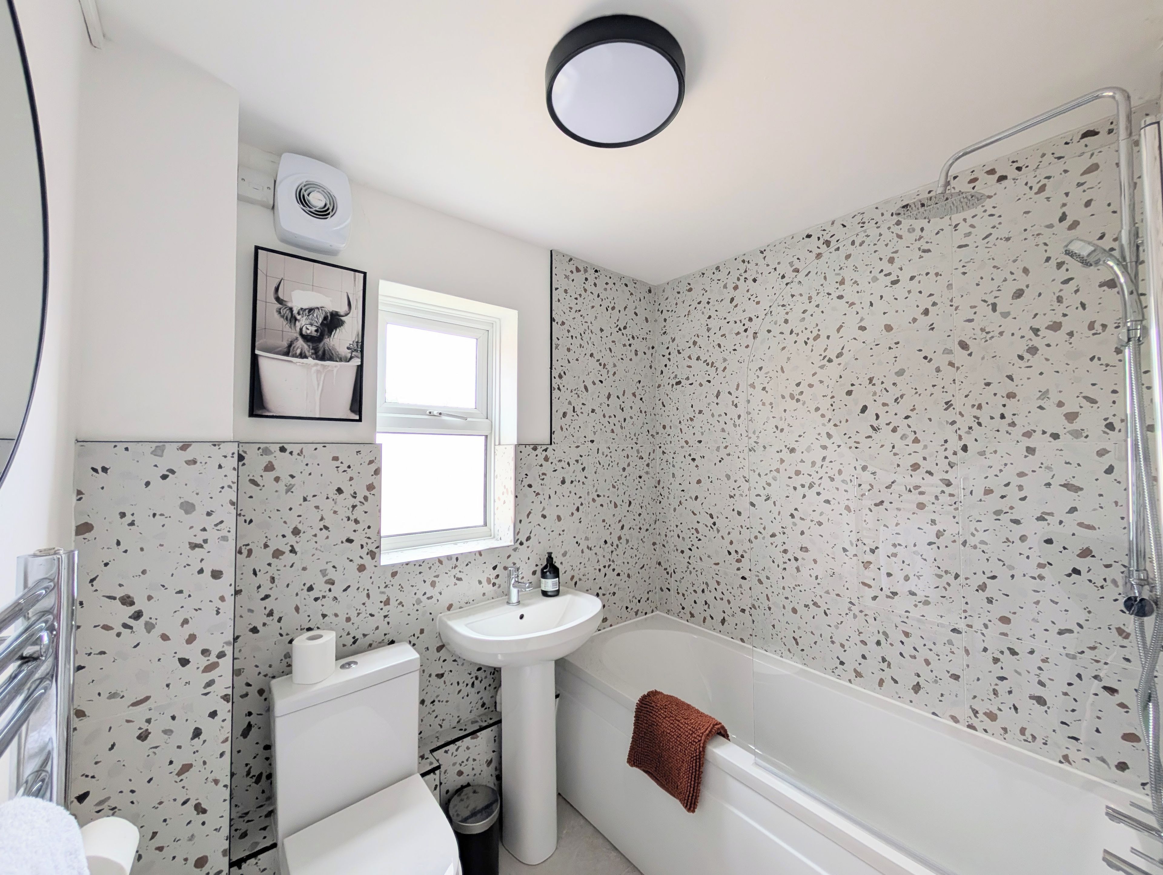 A bathroom with a bathtub, a sink, a toilet, and a shower.