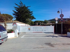 A gated entrance with a sign indicating 'RESIDENCIAL CABO DE TRAFALGAR' and a speed limit sign of 30. - Casa Montecote Playa  – Beach House Near Caños de Meca & Trafalgar (Barbate)