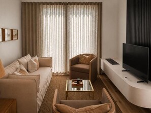 A modern living room with a sofa, armchair, and coffee table. - Superior One-bedroom Garden - Unit 4 (Stellenbosch)