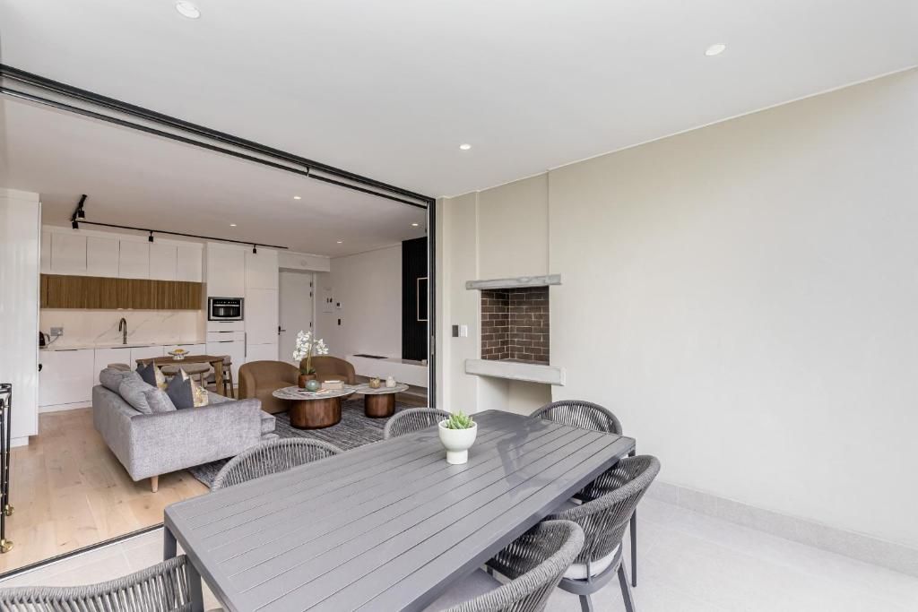 A modern interior with a dining area, kitchen, and living space.