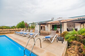 A poolside area with lounge chairs and a covered seating area. - Villa La Finquita - By Dream Villas Pollensa (Pollensa)