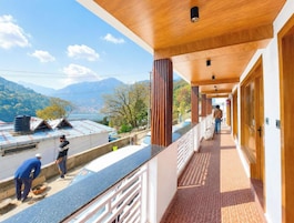 Un pasillo de hotel con vistas a montañas y un lago.