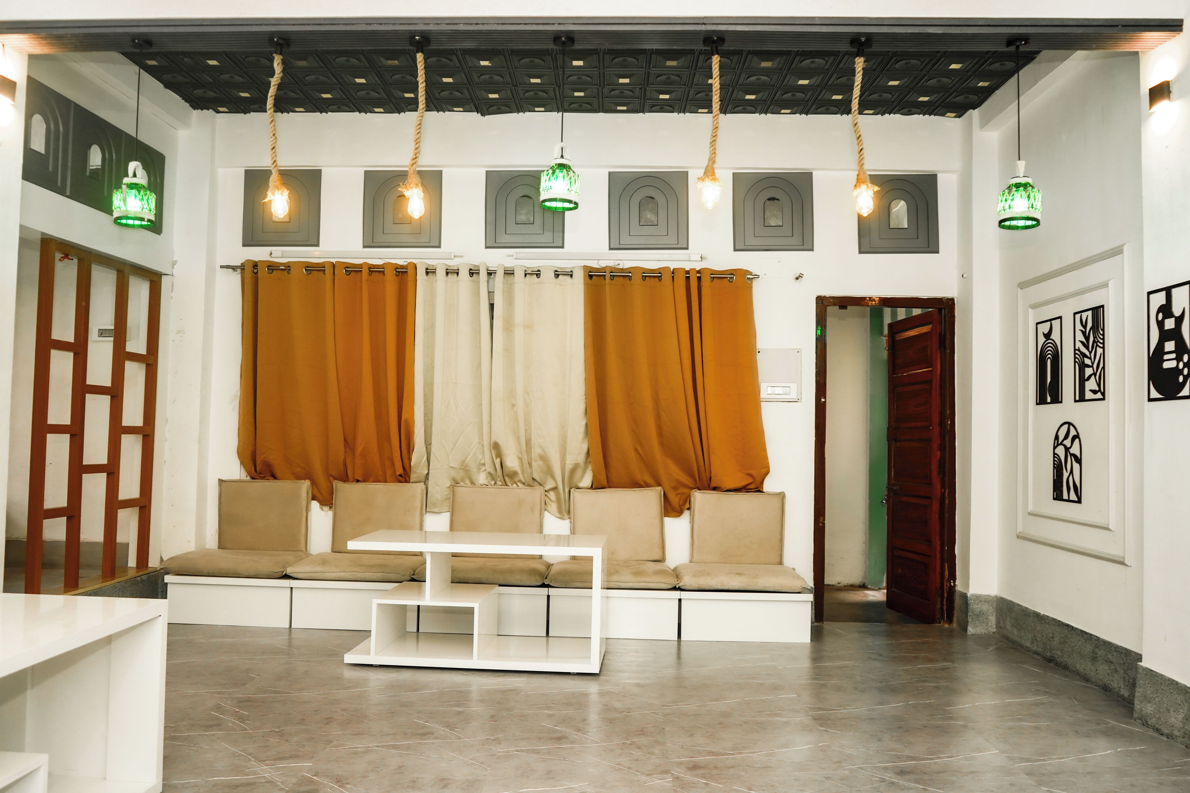 A modern interior with a seating area, a table, and a door leading to another room.