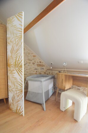 A room with a sloped ceiling, a small desk, a chair, and a bed with a headboard. - Fabuleuse maison de campagne avec jardin proche Thoiry, Versailles (Auteuil)