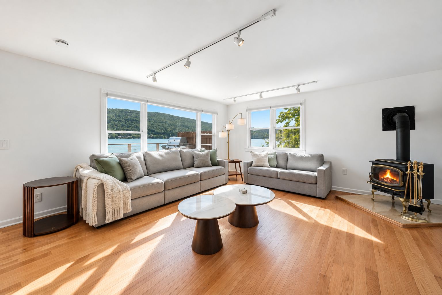 A spacious living room with a large sofa, a coffee table, and a fireplace.