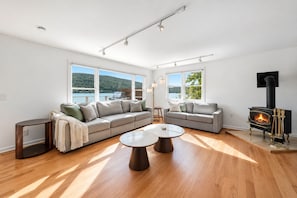 A spacious living room with a large sofa, a coffee table, and a fireplace.