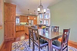 A spacious kitchen with wooden cabinets, a central island, and pendant lighting. - Spacious SLT Retreat w Forest Views (South Lake Tahoe)