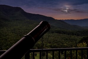 A telescope on a balcony overlooking a mountainous landscape. - Panoramic Smoky Mountain Views, Indoor Pool, 2 BD (Gatlinburg)