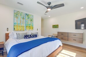 A bedroom with a bed, a ceiling fan, wall art, a TV, and a wooden dresser. - Steps to Blue Mountain Beach! 30A Getaway w/ Deck (Santa Rosa Beach)