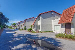 A row of houses with red-tiled roofs and stucco walls, a bicycle parked in front, and a clear blue sky. - Steps to Blue Mountain Beach! 30A Getaway w/ Deck (Santa Rosa Beach)