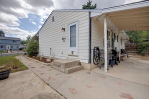 A residential house with a covered porch, a grill, and a small garden. - Walk to Prospect Lake! Great Backyard and Porch! (Colorado Springs)