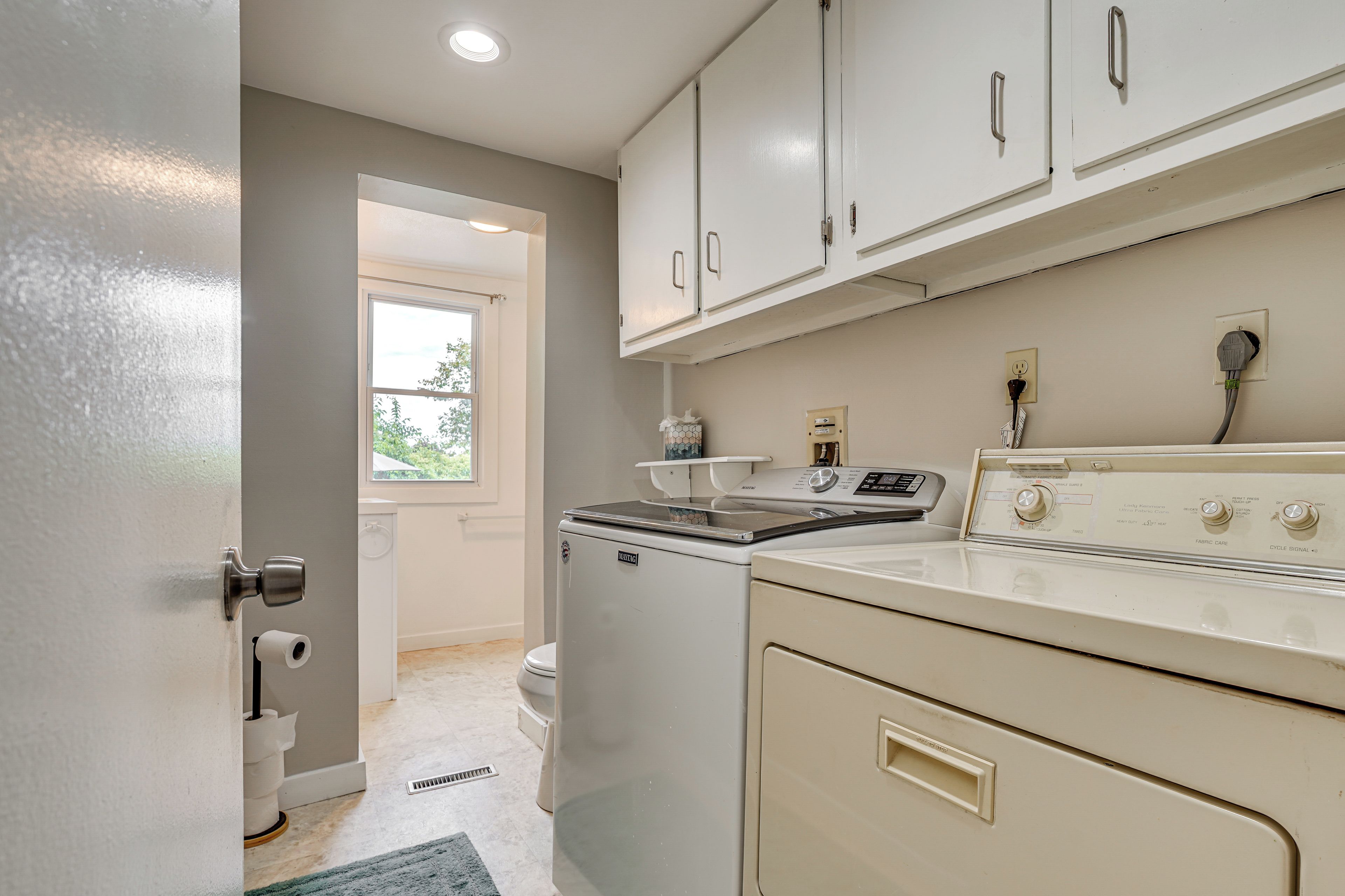 A compact kitchen with a stove, oven, and a washing machine.