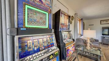 A slot machine with a screen displaying game results, a payline chart, and a cash payout table.