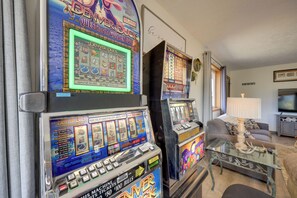 A slot machine with a screen displaying game results, a payline chart, and a cash payout table.