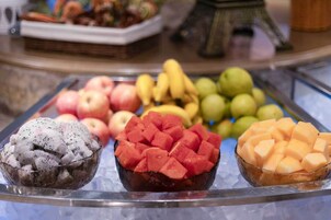 Un bufé con diversas frutas y una reproducción decorativa de la Torre Eiffel.