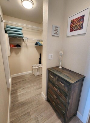 A laundry room with a wooden cabinet, a hanging rack, and a framed picture on the wall. - Premium Peaceful Intracoastal Retreat | 2BR • 2BA • Sleeps 6 (Indian Shores)