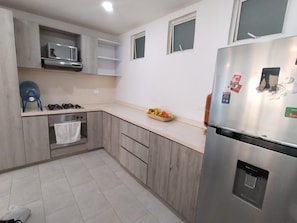 A kitchen with a built-in oven, a refrigerator, and a microwave. - Inspiration from the Sea (Cartagena)