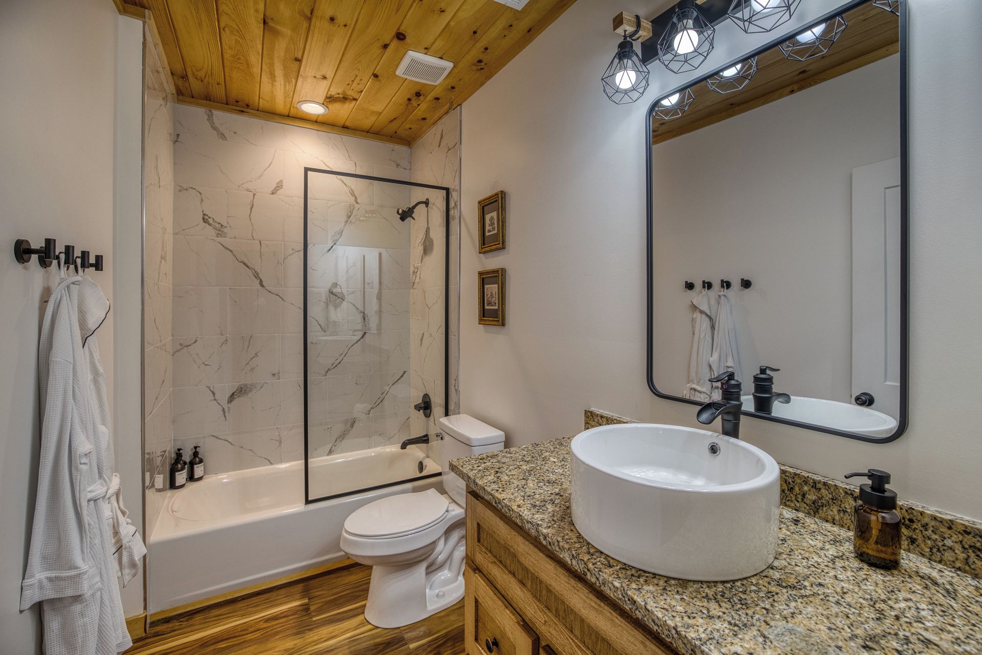 A bathroom with a bathtub, toilet, and sink.