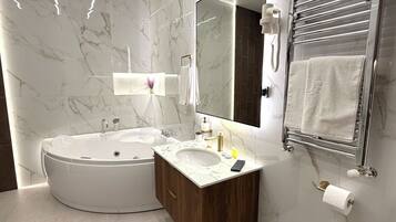 A modern bathroom with a freestanding bathtub, a vanity with a sink, and a large mirror.