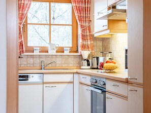 A kitchen with a window, a coffee maker, a toaster, and a sink. - 3.4/t3 Holiday Home Park \"freesenbruch\" (Zingst)