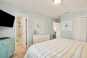 A bedroom with a bed, dresser, and a television. - Grand Strand Little Retreat (Garden City Beach)