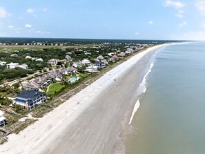 A coastal residential area with houses along the beach, a clear sky, and a calm sea. - A Place To Land 3 Bedroom Villa (Georgetown)