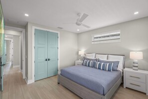 A bedroom with a bed, bedside tables, a ceiling fan, and a window with blinds. - Luxury Pet Friendly Waterfront Home Private Pool & Dock in Resort Community Manatee Dreams at Hunters Point (Cortez)