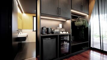 A modern kitchen with a built-in dishwasher, a coffee machine, and a wine cooler.