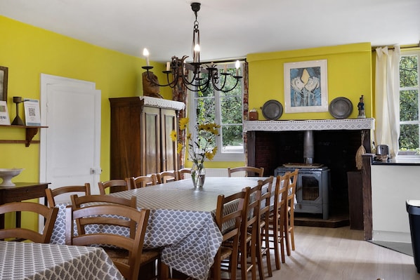 A dining area with a table set for six, surrounded by wooden chairs.