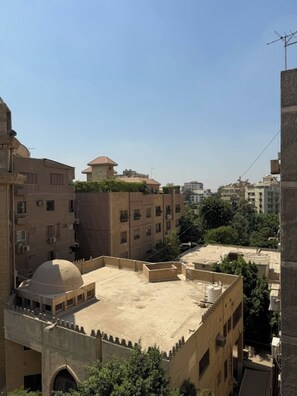 A residential area with multiple buildings, some with flat rooftops and others with domed structures. - Degla Maadi Urban Nest 3 Brm Apartment (Cairo)