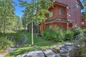 A multi-story wooden building with a stone pathway leading to the entrance. - New! Mountain Condo | Fireplace | Shared Hot Tub | 1 Mile to Purgatory Resort (Durango)
