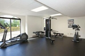 A gym with cardio machines, weight training equipment, and a bench. - Upper Vill 1BR: Walk to Ski-In/Out, Sleeps 4! Hot Tub, Sauna & Gym. (Whistler)