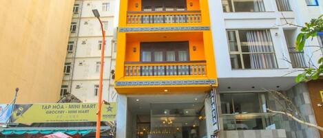 A multi-story building with a ground-floor entrance, a visible staircase, and a sign for a hotel named ZENTARA.