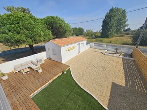 A residential property with a wooden deck, a small white building with a tiled roof, and a fenced yard. - Villa Victoria 5*, Oceanfront, Pool, Air Conditioning, Renovated Home, New Amenities (L'Aiguillon-la-Presqu'île)