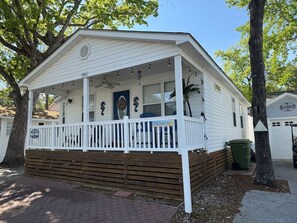 A single-story house with a porch, a garage, and a small front yard. - Short Walk to Beach, Cozy Stay in Ocean Lakes (Myrtle Beach)