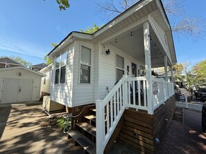 A single-story house with a porch, a garage, and a small front yard. - Short Walk to Beach, Cozy Stay in Ocean Lakes (Myrtle Beach)