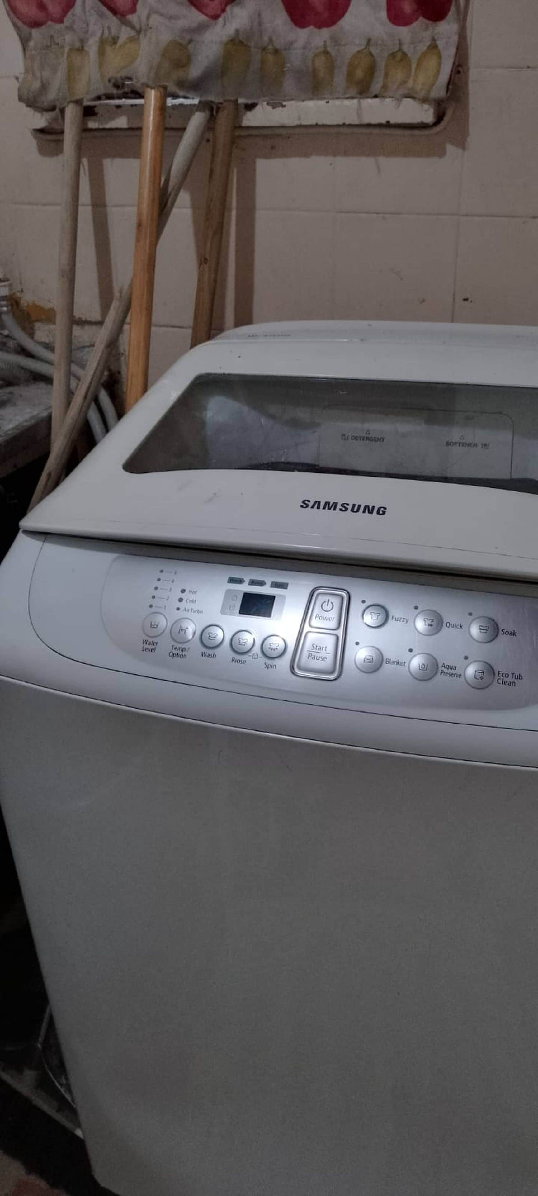 A Samsung washing machine with a control panel featuring multiple buttons for various functions.