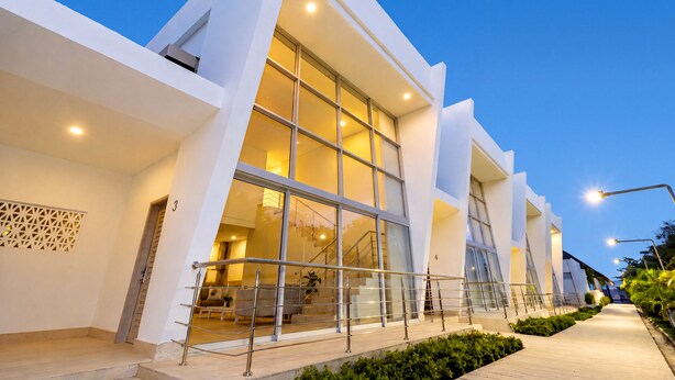A modern building with large windows, a staircase, and a well-lit entrance. - CASA PRIVADA 4 - AREIA BARU (Bolívar)