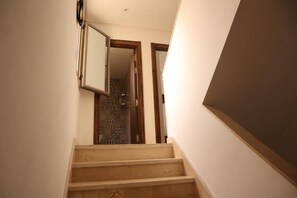 A staircase leading to a room with a patterned floor. - Surf and Stay Villa Anza (Agadir)