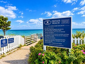 A private beach sign with rules for beachgoers, a wooden walkway, and a white picket fence. - A Storybook Cape Cod Cottage by the Sea (Mashpee)
