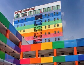 A multi-story building with the sign 'HOTEL AMERICA' at the top. - Fave Hotel Angeles City (Angeles City)