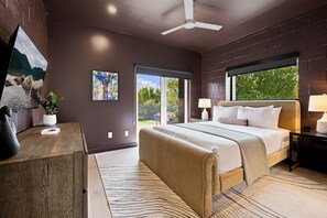 A modern bedroom with a large bed, a desk, and a view of the outdoors. - The Aperture - Garage - 0.5 mi DT (Bentonville)