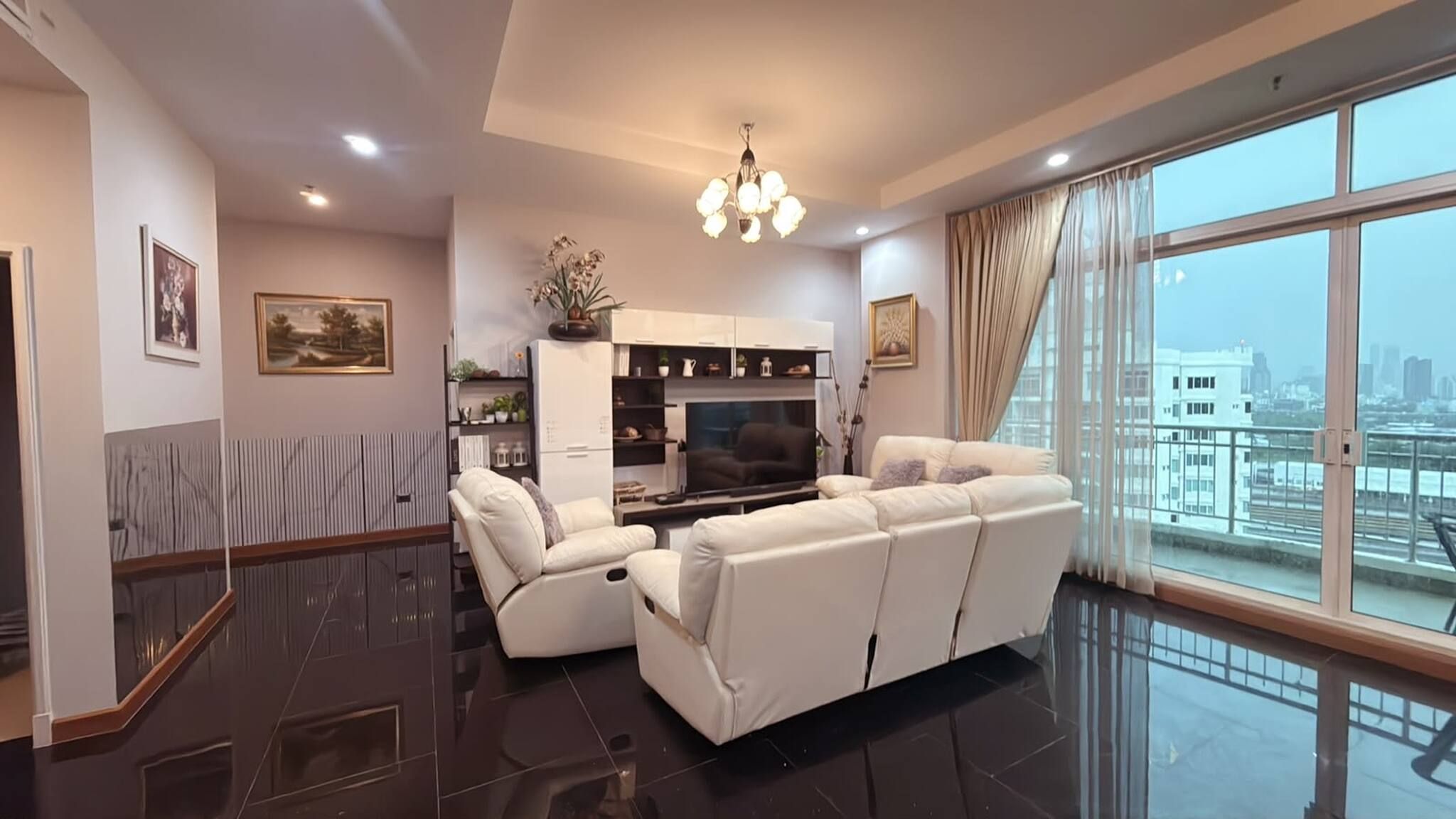 A modern living room with a sofa, a TV, and a decorative cabinet.