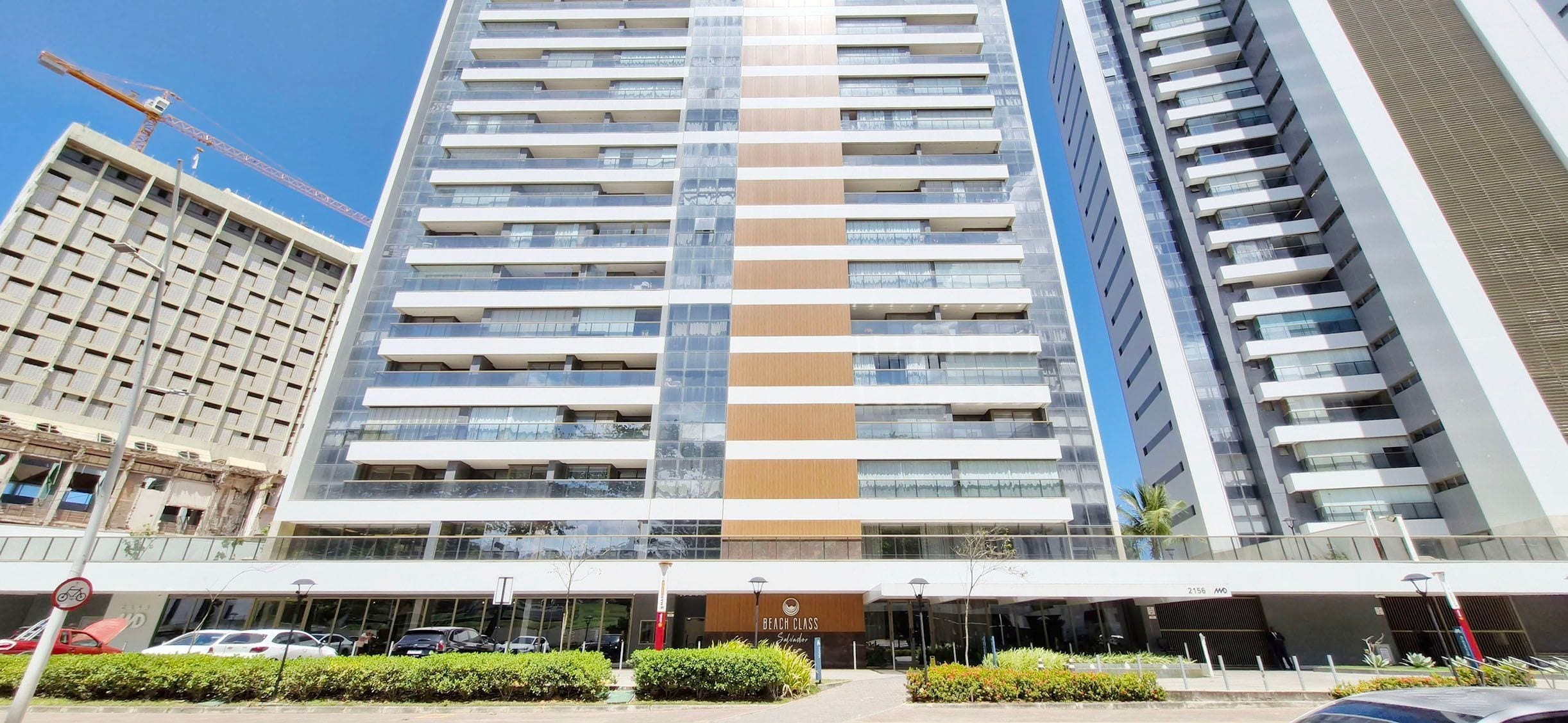 A multi-story hotel with a modern facade, a prominent entrance, and a view of the surrounding urban area.
