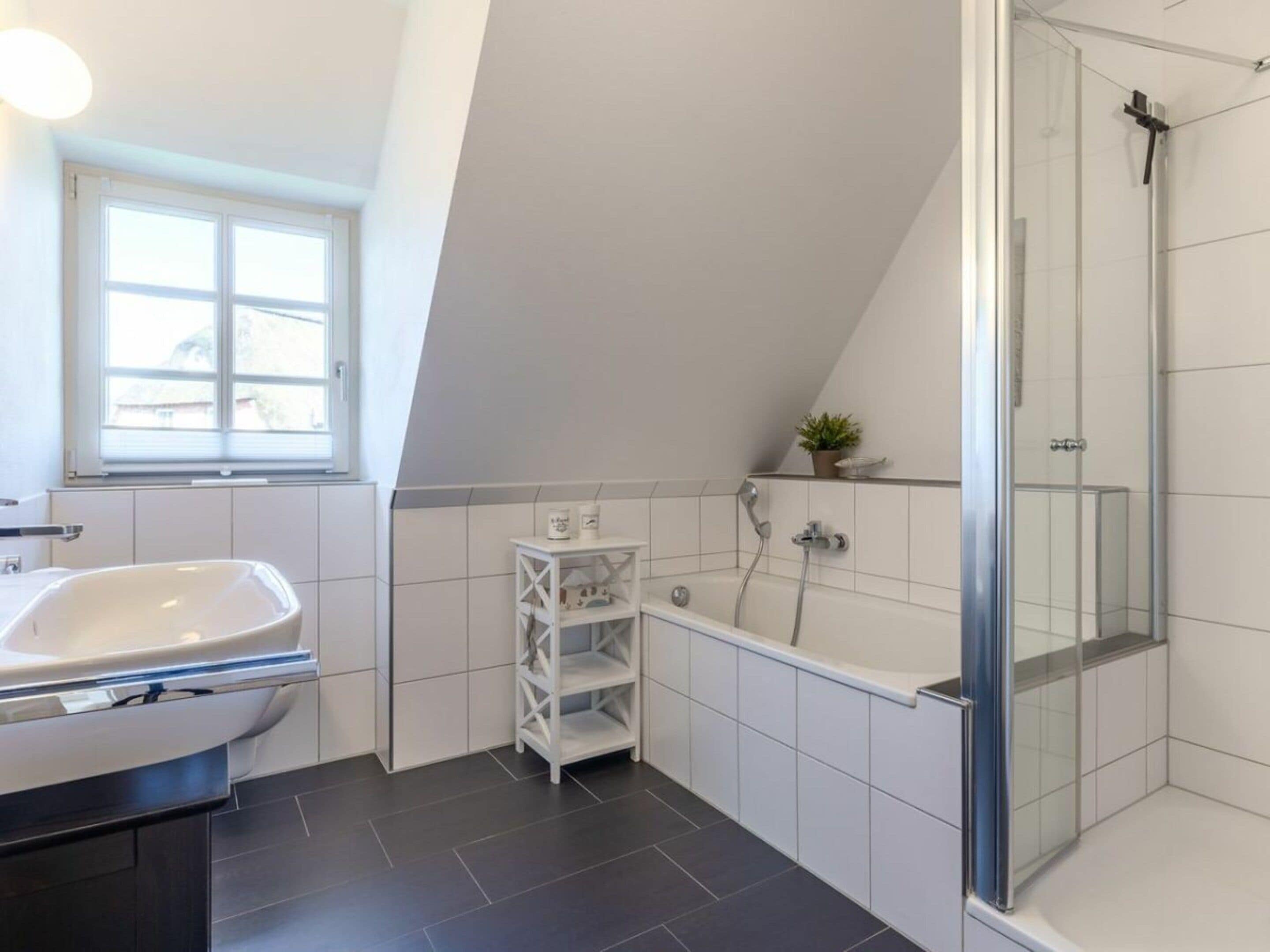 A modern bathroom with a freestanding bathtub, a shower enclosure, and a vanity with a sink.