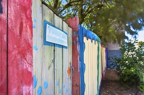 A wooden fence with a sign that reads 'Bohemian Bungalow.' - 1BR · Sleeps 3 · Dog-Friendly · Shared Hot Tub (Saint Augustine)