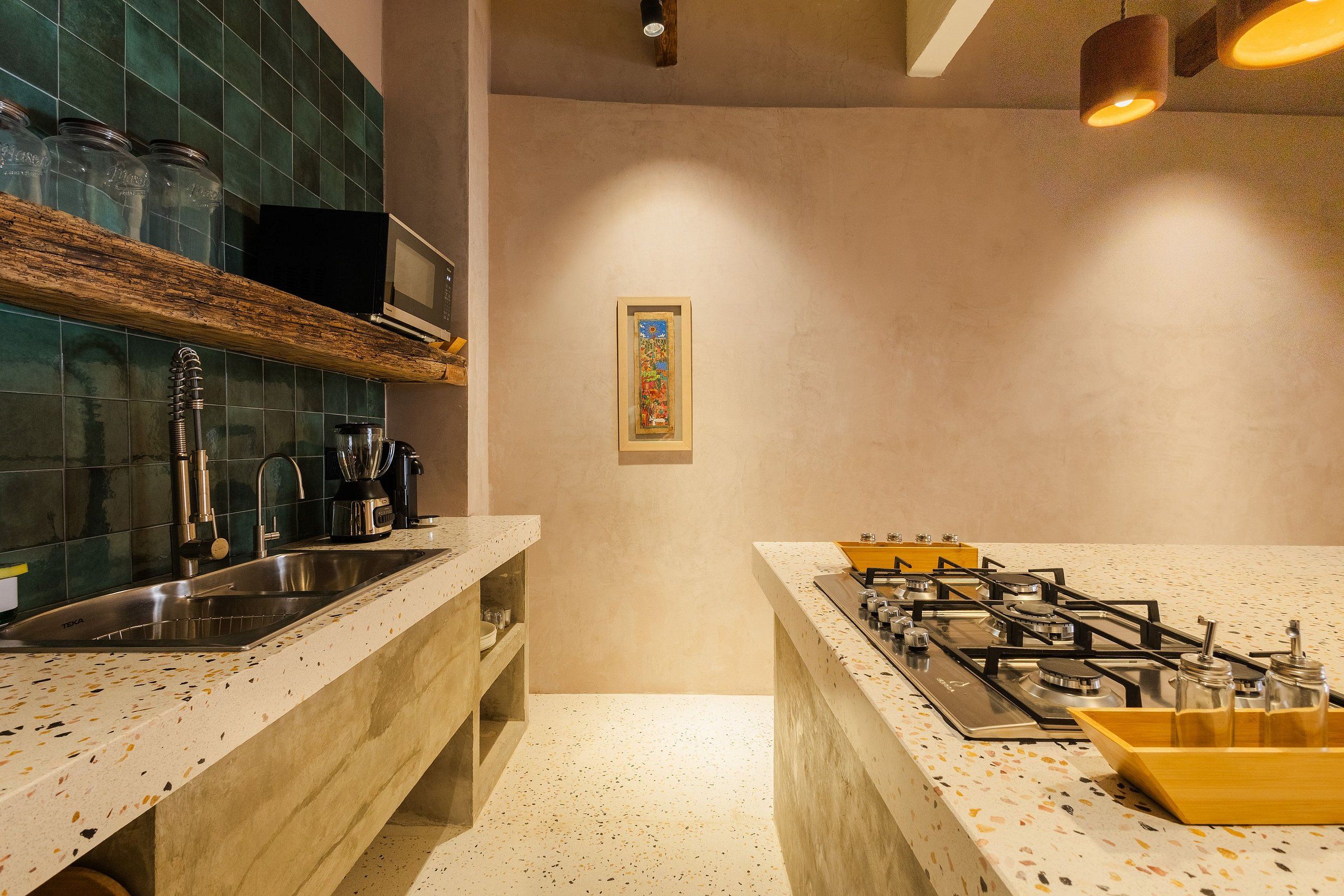 A kitchen with a gas stove, a sink, and a microwave.