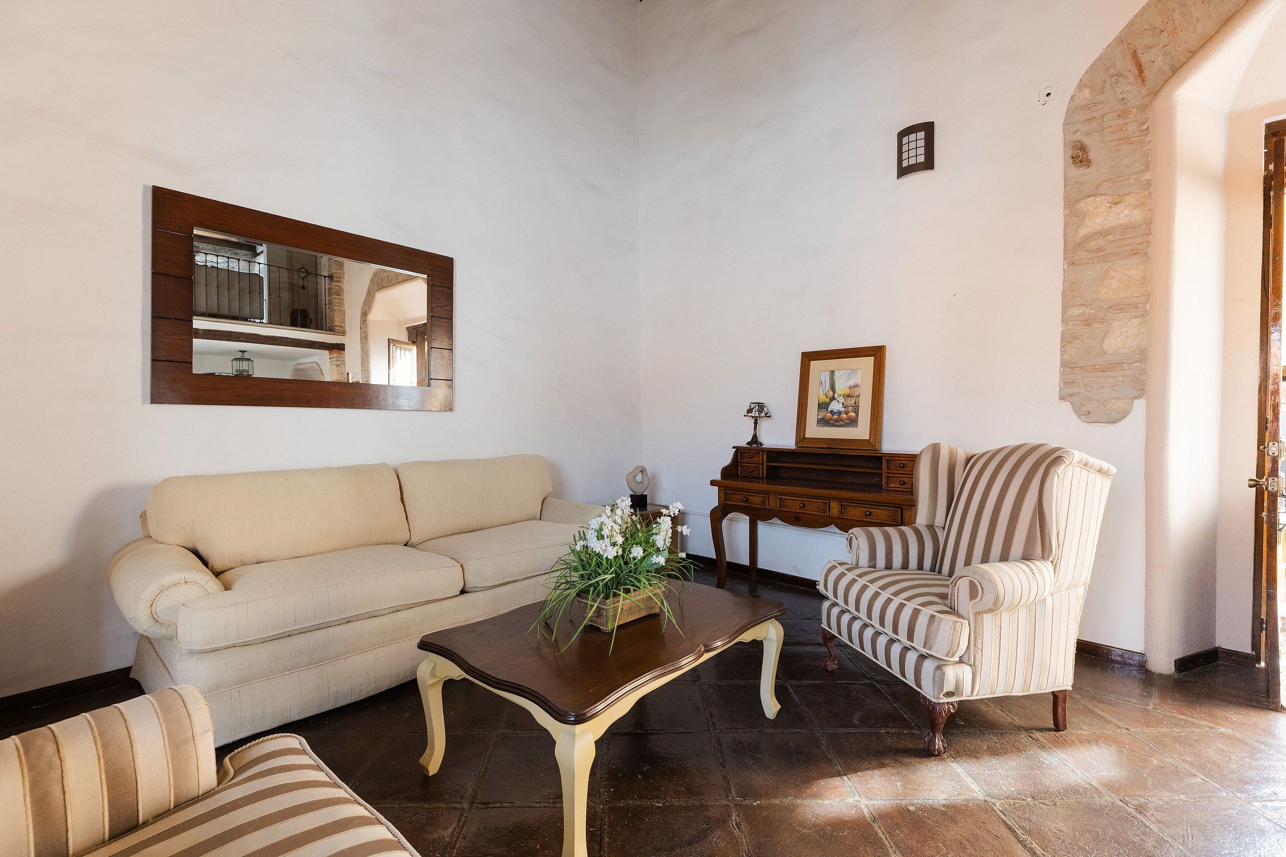A living room with a sofa, armchair, and a coffee table.