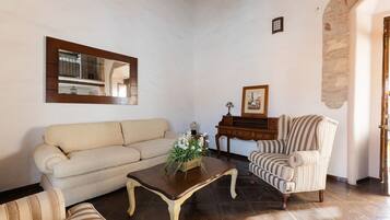 A living room with a sofa, armchair, and a coffee table.