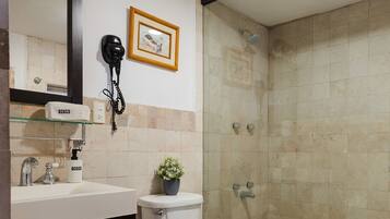 A bathroom with a toilet, sink, and shower.